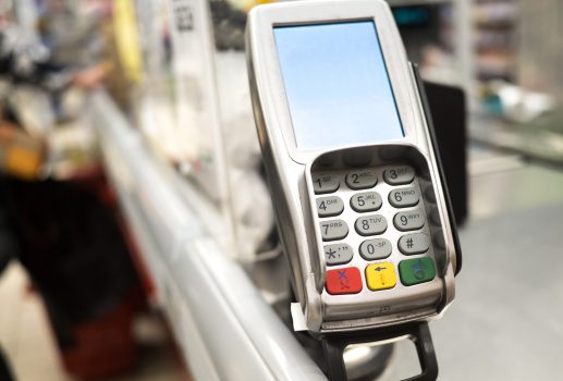 Payment terminal with keypad at a cash register in a shopping center